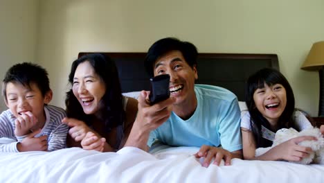 Happy-family-watching-television-in-the-bedroom-4k