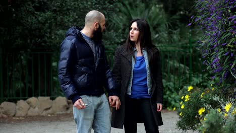 engaged-couple-at-the-park-begins-a-lively-discussion