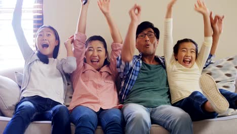 Excited-family-watching-television-together-in-living-room-4k