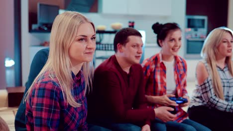 Happy-group-of-friends-socializing-at-home-and-playing-video-game