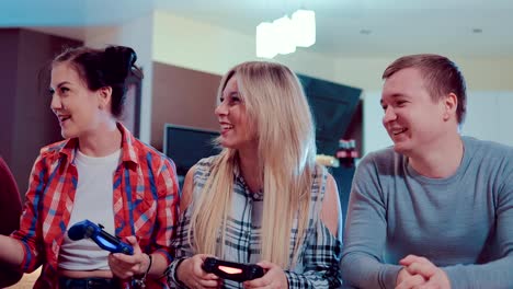 Happy-group-of-friends-socializing-at-home-and-playing-video-game