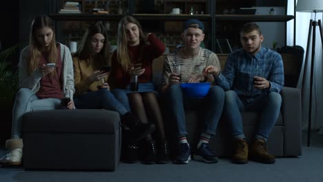 Group-of-young-friends-watching-sport-tv-at-home