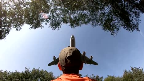 Airplane-flies-over-a-boy-on-landing