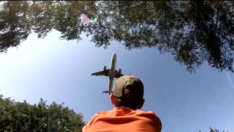 Airplane-flies-over-a-boy-on-landing