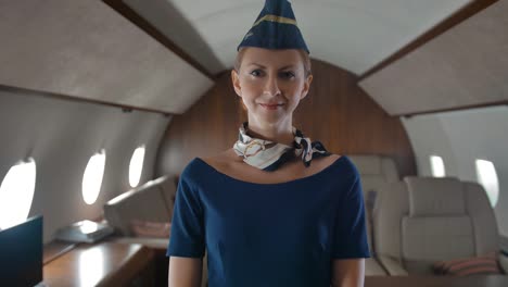 Portrait-of-young-air-hostess-inside-of-private-jet-cabin