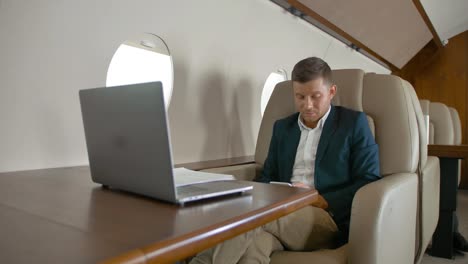 Businessman-chat-and-sit-in-armchair-in-private-jet