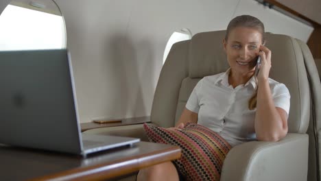 Happy-lady-speaking-about-luxury-journey-inside-of-private-jet