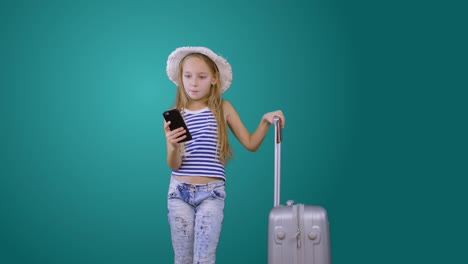 Tourist-girl-with-travel-suitcase-and-mobile-phone-isolated-on-green-background