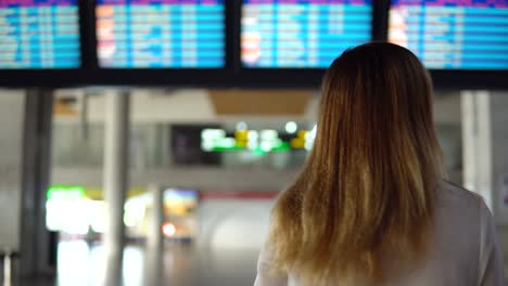 Cute-girl-in-casual-clothes-is-sad-in-an-empty-airport-terminal-was-late-for-the-plane