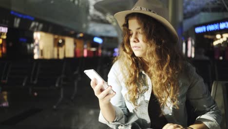 Young-woman-sitting-in-airport