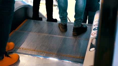 Legs-of-People-Moving-on-an-Escalator-Lift-in-Shopping-Center