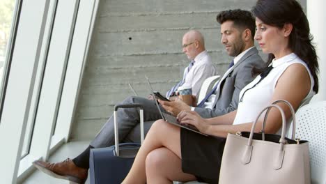 Businesswoman-Using-Laptop-In-Airport-Lounge-Shot-On-R3D