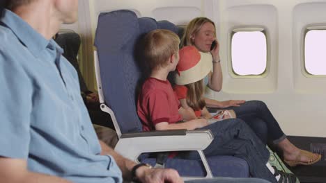 Family-using-cellphone-on-plane