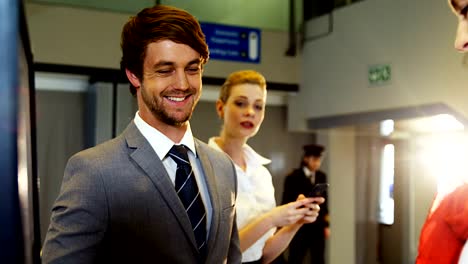 Businessman-showing-his-boarding-pass-at-the-check-in-counter