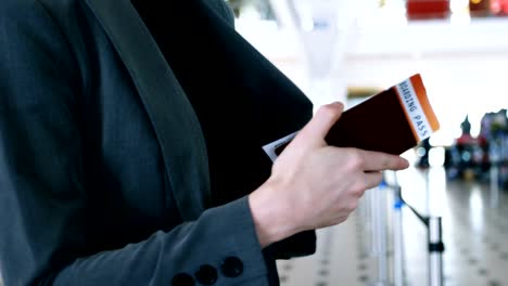 Passengers-standing-with-boarding-pass-in-queue