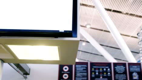 Businesswoman-showing-her-boarding-pass-at-the-check-in-counter