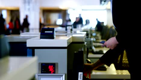 Businessman-showing-his-boarding-pass-at-the-check-in-counter