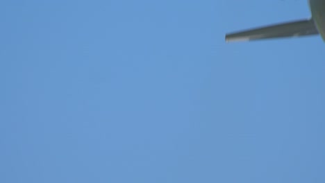 Airplane-taking-off-in-blue-sky,-extremely-closeup