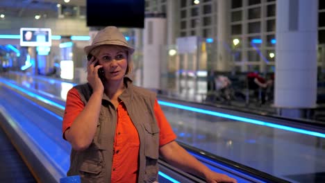 A-Woman-In-The-Airport-And-Talking-On-The-Phone.