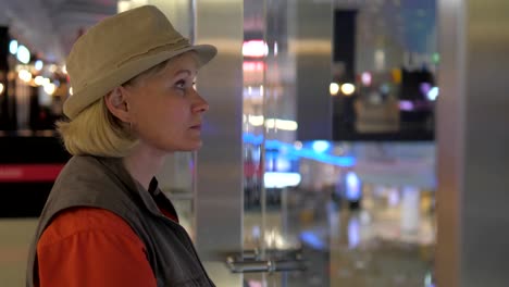 An-Adult-Woman-Looks-Around-The-Airport.