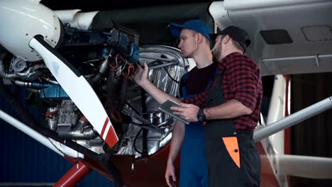 Two-flight-mechanics-doing-a-pre-flight-check