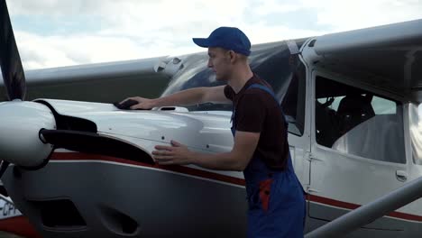 Young-pilot-or-mechanic-working-on-an-aircraft