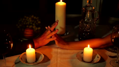 Close-up-Of-The-Hands-Of-Men-Holding-Women's-Hands-During-A-Romantic-Dinner