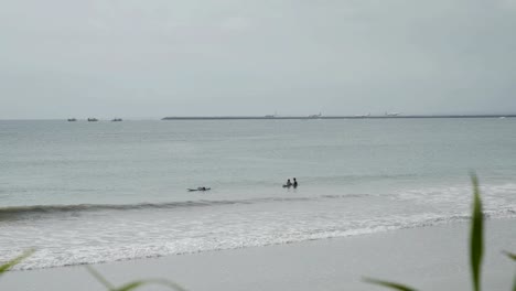 Airplane-landing-on-island-Bali-airport-under-blue-sea-with-waves-on-horizon