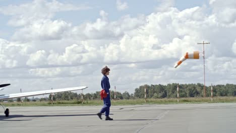 Female-Aircraft-Technician-Walking-on-Aerodrome