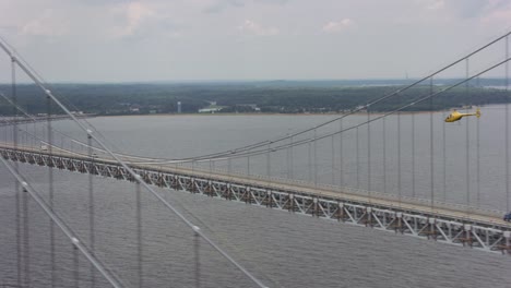 Aerial-shot-of-helicopter-flying-by-the-Chesapeake-Bay-Bridge.