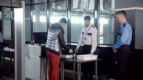 Guard-checking-passenger-bag-in-airport