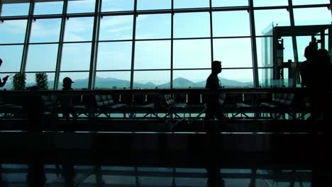 Silhouette-der-Geschäftsmann-Passagiere-zu-Fuß-in-der-geschäftigen-Flughafen-Gebäude