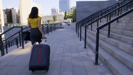 Back-view-asian-business-woman-with-suitcase