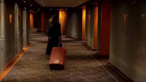 Hotel-guest-with-trolley-case-walking-to-the-room