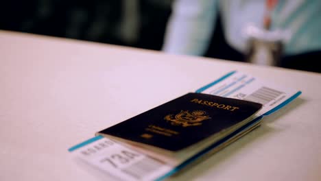 Traveler's-passport-and-boarding-pass-on-airport-check-in-desk