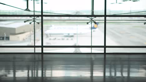 Male-Young-passenger-walking-with-suitcase-luggage-in-departure-area-of-airport-terminal.-Asian-businessman-in-casual-clothing-on-business-trip.-Modern-travel-lifestyle-concepts.