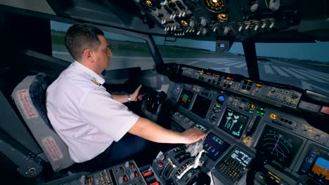 A-pilot-controls-a-plane-on-a-runway.