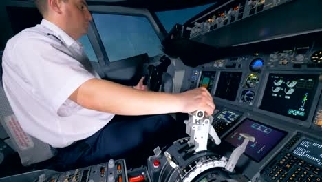 An-airman-controls-a-plane,-close-up.