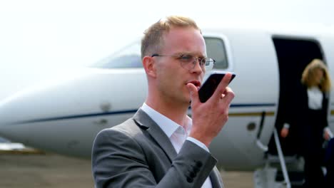 Businessman-talking-on-mobile-phone-at-terminal-4k