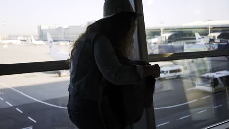 Woman-with-ticket-and-backpack-in-airport