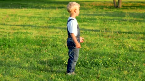 Elementary-aged-boy-kicking-ball-in-the-field