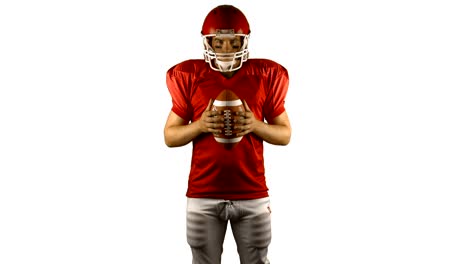 Red-american-football-player-holding-a-ball