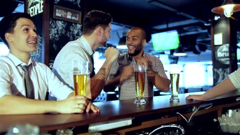 Men-fans-watching-football-on-TV-and-drink-beer
