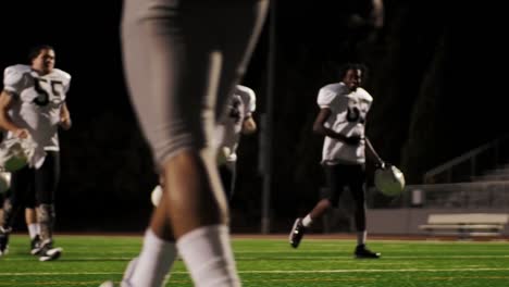 Close-up-of-a-football-player's-feet-as-he-hits-a-row-of-sleds