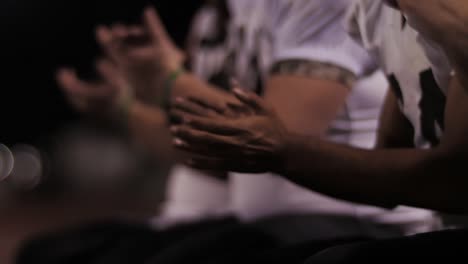 Close-up-on-the-hands-of-football-players-cheering-on-their-teammates-from-the-sidelines