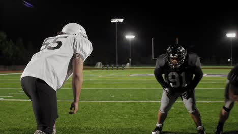 A-football-player-tackles-his-opponent-and-another-player-dives-on-the-ball