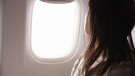 Closeup-of-woman-using-cell-phone-on-airplane