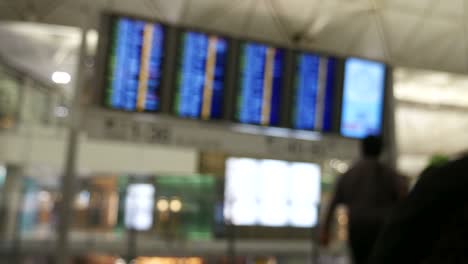 People-at-departure-board-in-airport