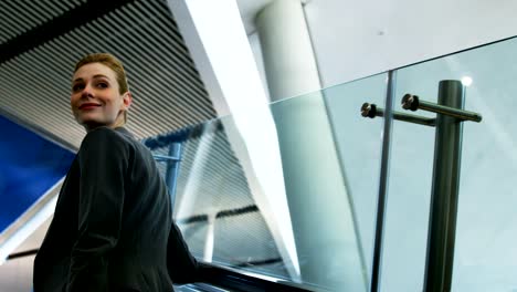 Businesswoman-standing-on-an-escalator