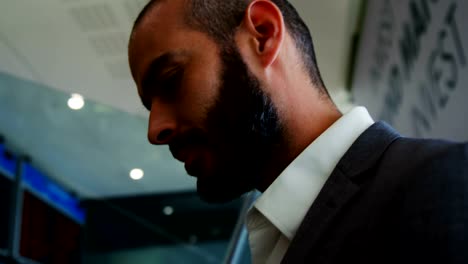 Businessman-standing-on-an-escalator